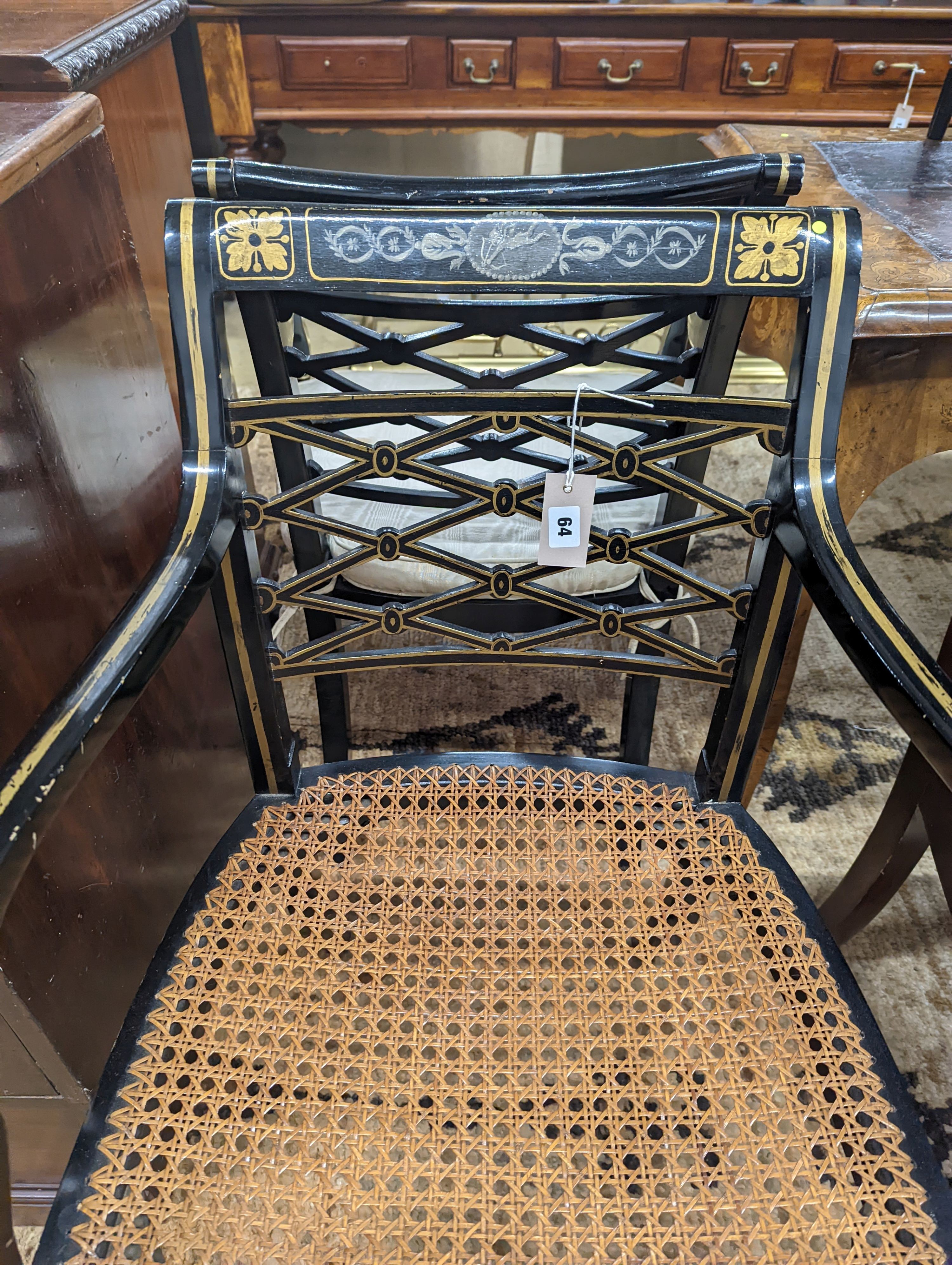 A pair of Regency style painted cane seat elbow chairs, width 52cm, depth 47cm, height 84cm